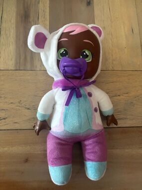 Plush Baby Doll in White Hooded Outfit with Purple Accents and Purple Pacifier